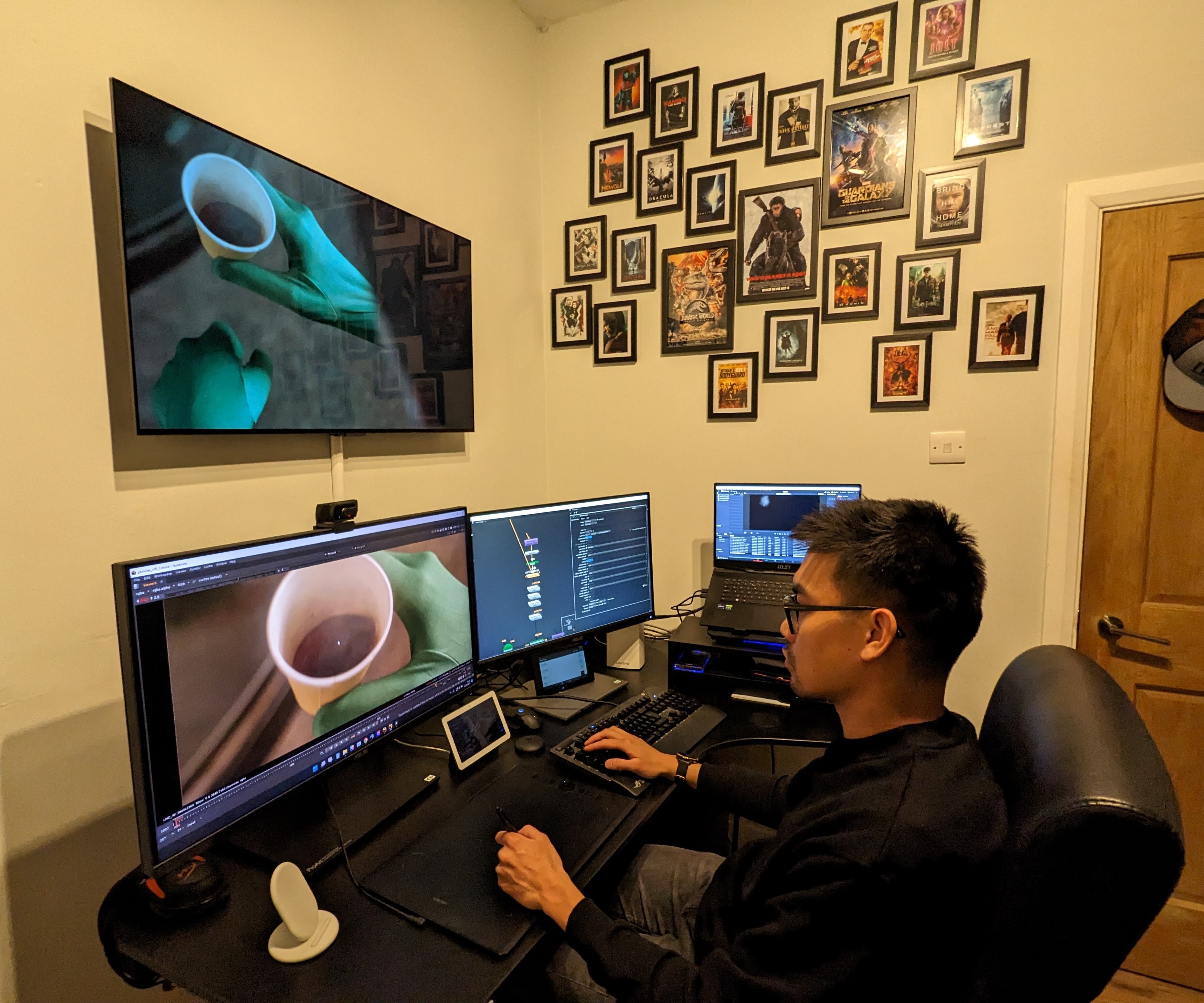 Digital compositor Mark Millena at work in his home office. Yes, that is indeed a furry friend in his lap.